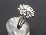 a close up of a diamond ring sitting on top of a crystal block