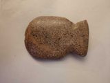 a stone fish on a table with a white background