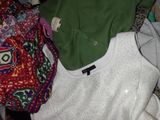 a pile of clothes that is sitting in a laundry basket
