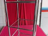 an image of a metal cart with a pink cloth