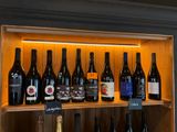 Des bouteilles de vin sont alignées sur une étagère dans un magasin de vins.