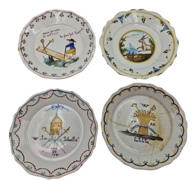 four plates with different designs on them on a white surface