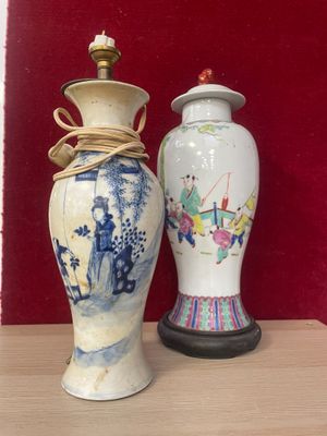 two vases sitting on a table with a red wall in the background