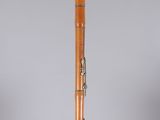 an old wooden baseball bat sitting on top of a clear base