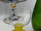 a green glass vase and a green glass vase on a table