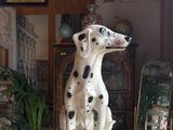 a statue of a dalmatian dog sitting on top of a table