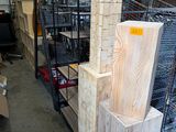 several stacks of wood are stacked on top of each other in a warehouse