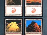 four cards with different images of mountains on them on a table