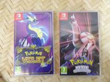 a couple of nintendo wii games sitting on top of a table