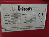 the machine is red and has a white sticker on it