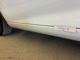 a sticker on the side of a white car