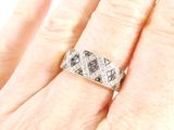 a close up of a person ' s hand holding a diamond ring