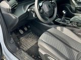the interior of a car with the door open and the driver ' s seat down