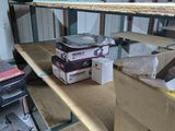 a shelf with boxes and boxes on it in a garage