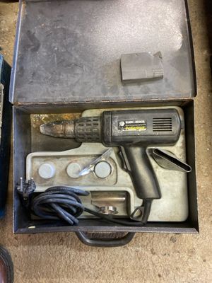 a box with a drill and other tools in it