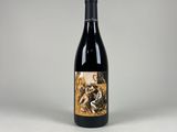 a bottle of wine sitting on top of a white table