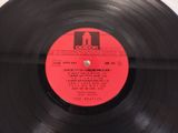 a black record with a red label on it