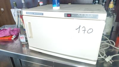 a white microwave sitting on top of a metal counter