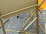 two chairs that are sitting next to each other on the pavement