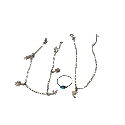 three pieces of silver jewelry on a white background