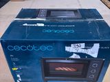 a box with a microwave inside of it sitting on the floor