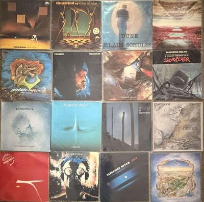 many different album covers on the wall of a room