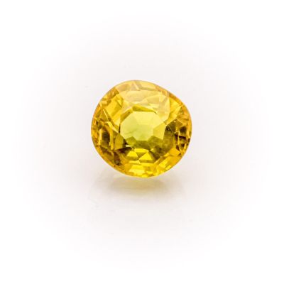 a yellow sapphire stone on a white background