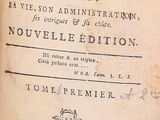 an old book with writing on it sitting on a table