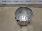 an image of a stainless steel bucket on a concrete floor