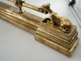 a gold statue of a horse and a dog on top of a table