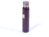 a bottle of liquid sitting on a white surface