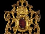 une image représentant un pendentif en or et en grenat sur fond noir