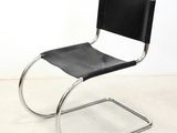 a black and chrome chair with a black leather seat