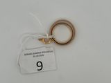 a small gold ring with a tag attached to it