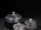 three clear glass containers sitting on top of a black surface