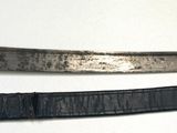 pair of old and worn swords on a white surface