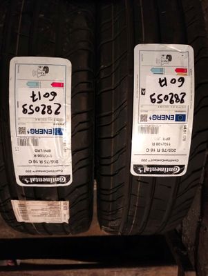 two tires on a shelf with price tags on them