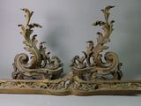 a pair of ornate wooden sculptures on a white surface