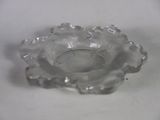 a clear glass candle holder on a white table