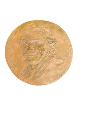 a gold medal with a picture of a man on it