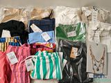 many different types of clothing on display on a shelf