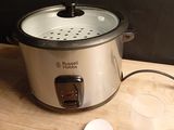 a crock pot and a spoon sitting on a table
