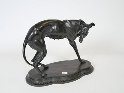 bronze statue of a cheetah standing on a base