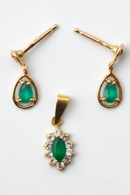 a pair of emerald and diamond earrings and a pendant