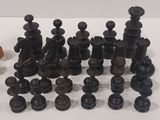 a lot of black chess pieces on a white table