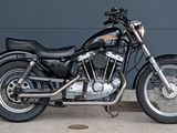 a black motorcycle parked in front of a garage door