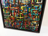 peinture abstraite représentant des carrés et des rectangles multicolores, dans un cadre noir