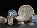 many different types of vases and plates on the table
