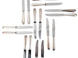 a lot of knives that are on a white surface