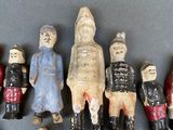 many figurines of different sizes and colors on the table